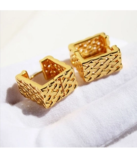 Macro view of gold rectangular hoop earrings with intricate mesh texture and 18K finish