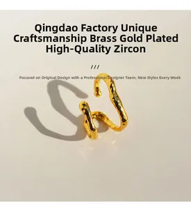 Detail of gold plated brass ear cuff with irregular hammered texture and zircon inlay