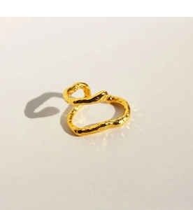 Detailed view of an adjustable golden ring with hammer-textured wavy minimalist design