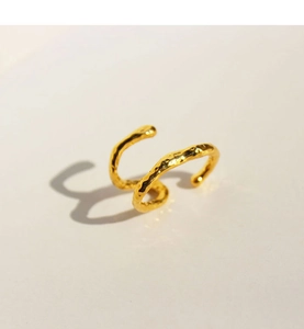 Detail shot of golden double-layer ear cuff featuring handcrafted hammered texture finish