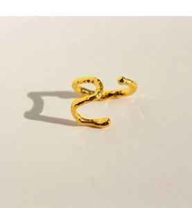 Macro shot of minimalist gold double-layer ear cuff with textured hammered finish detail