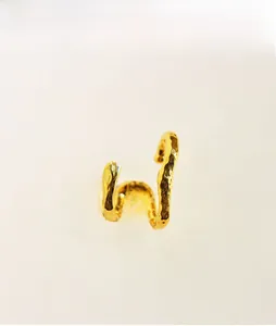 Close-up of gold double-layered ear cuff featuring an irregular hammered texture finish