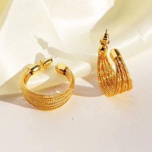 Golden woven multi-layer C-shaped hoop earrings with textured metal wire finish