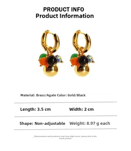Detail view of gold brass earrings with agate beads showing 3.5cm length measurements