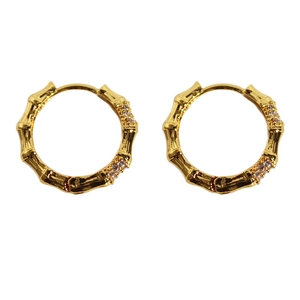 Gold bamboo style hoop earrings with sparkling zircon accents on white background