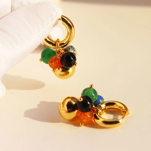 Golden hoop earrings with colorful agate and metal beads in a bohemian jewelry style
