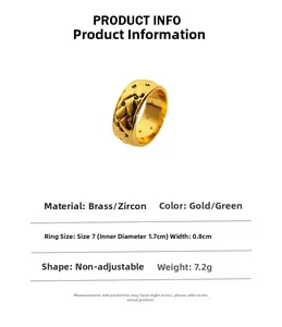 Detail view of gold brass ring with green zircon stones and quilted pattern engraving