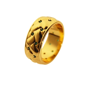 Vintage gold wide ring with quilted lattice pattern and green zircon stones on white background