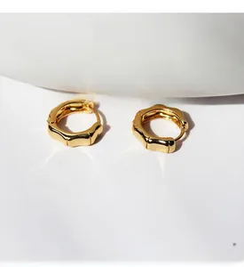 Detail shot of brass gold-plated bamboo-style earrings with sparkling zircon stones