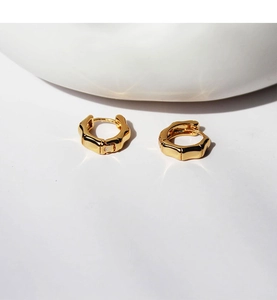 Detailed view of gold-plated brass bamboo texture hoop earrings with polished finish