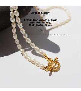 Detailed close-up of gold-plated brass OT clasp with zircon and freshwater pearls