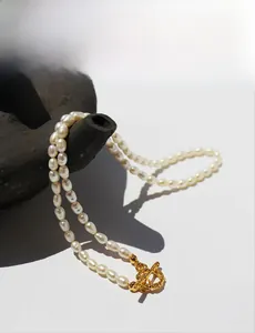 Detail of vintage freshwater pearl necklace with elegant golden OT toggle clasp closure