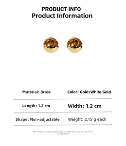 Macro view of mirror-polished hollow sphere earrings in gold and platinum finishes