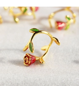 Macro shot of French vintage enamel red rose ring with detailed green leaves and gold band