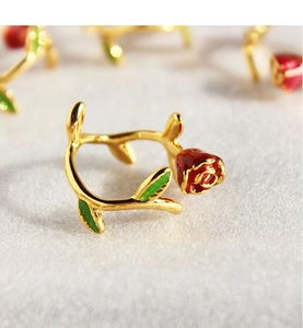 Detail showing the red rose bud and green leaves enamel on a gold-plated open ring