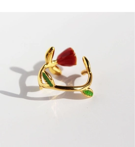 Detailed close-up of a vintage red enamel rose open ring with green leaf accents