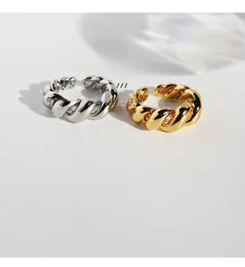 Detail of vintage twisted spiral rings in gold and silver brass with zircon stones