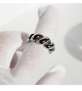 Detailed view of silver twisted croissant ring with high polish finish on white glove