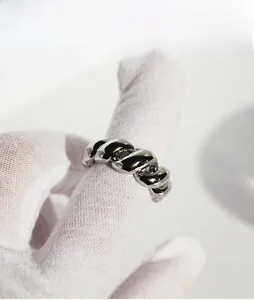 Macro detail of silver twisted rope textured ring with high-polished mirror finish