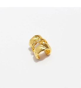Detailed view of triple-layered gold ear cuff with star patterns and sparkling zircon stones
