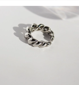 Close-up of polished silver twisted spiral ring showing exquisite metallic details
