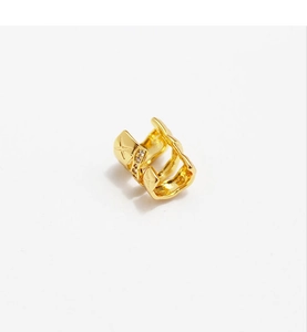 Detail of gold double-layered ear cuff with star patterns and zircon stone inlays