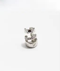 Detailed view of silver triple-layer ear cuff with diamond-set band and lattice pattern