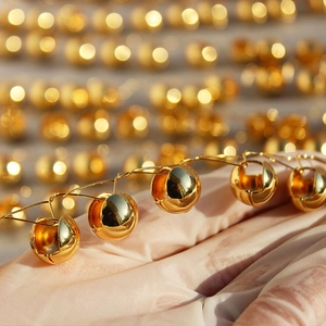 Polished gold mirror sphere hoop earrings with a minimalist geometric ball design for women