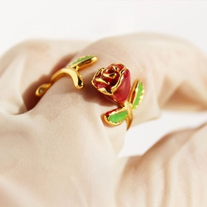 Elegant vintage red enamel rose open ring with gold-plated petals on silk background