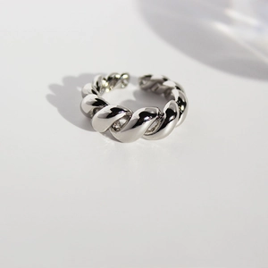 Minimalist silver twist spiral open ring with high-polished mirror finish in a studio setting