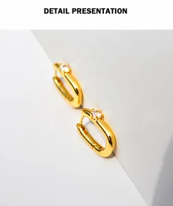 Detail presentation of 18K gold plated U-shaped earring with sparkling zircon stone