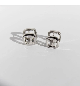 Close-up of silver minimalist geometric square hoop earrings with hollow metal design