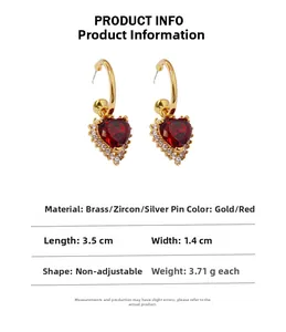 Detailed view of vintage ruby heart earrings with brass and zircon material specs