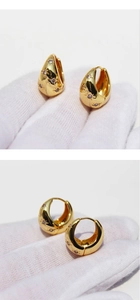 Detailed view of gold-plated hoop earrings with sparkling star-patterned zircon inlay