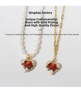 Detailed shot of vintage heart pendants with red enamel roses and white pearl chain necklace