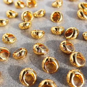 Chunky gold hoop earrings with engraved star patterns and sparkling zircon inlays