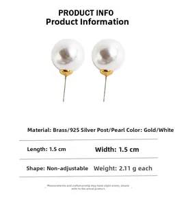 Detail view of 1.5cm round pearl stud earrings with gold finish and 925 silver needles