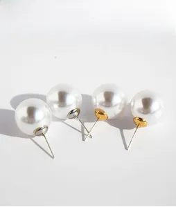 Detail presentation of four white round pearl earrings with silver and gold metal bases