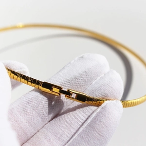 Flat gold snake chain necklace with diamond pattern texture and secure clasp closure