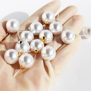 Lustrous round white pearl earrings with golden metal base and 925 silver needles
