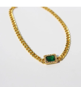 Detail of vintage gold plated Cuban link necklace with rectangular emerald zircon pendant