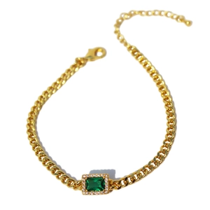 Gold Cuban link bracelet with rectangle emerald zircon and halo setting on white background