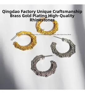 Close-up of C-shaped hammered texture brass earrings with gold and silver plating