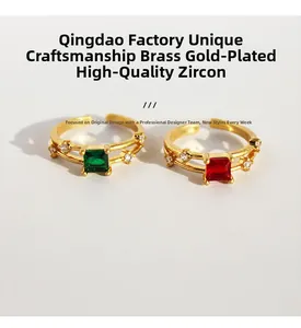 Dettaglio macro di anelli in ottone placcato oro con zirconi verde smeraldo e rosso rubino