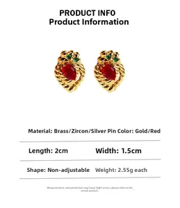Detailed view of strawberry gold earrings with red pear-cut zircon and silver needles