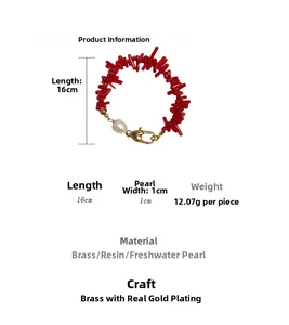 Macro detail of red resin beads bracelet with a freshwater pearl and gold lobster clasp