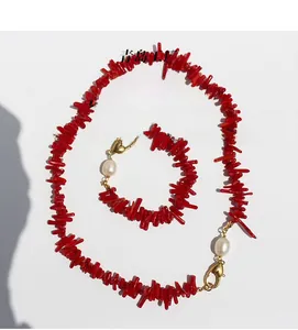Detail of red branch coral necklace with freshwater pearls and gold-plated heart clasp