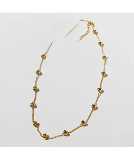 Detailed close-up of brass gold plated necklace featuring premium zircon heart charms