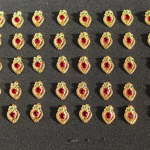 Vintage gold plated strawberry earrings with red and green zircons in grid display