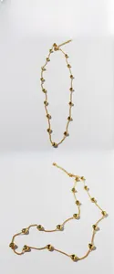 Detail view of golden heart pendant necklace with multiple small hearts on thin chain